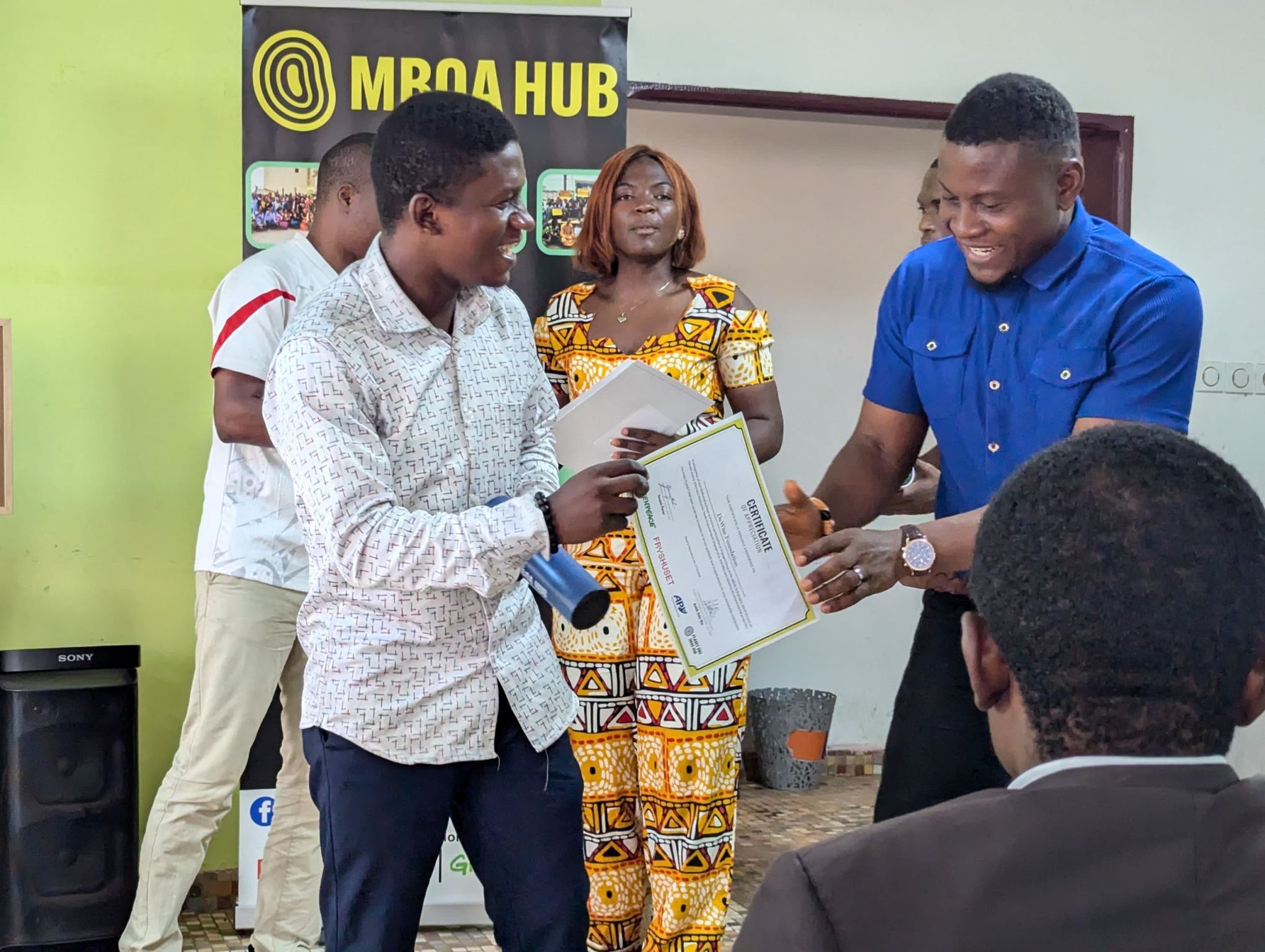 CEO Blaise and Country Director Christian receiving Mboa Hub certificate
