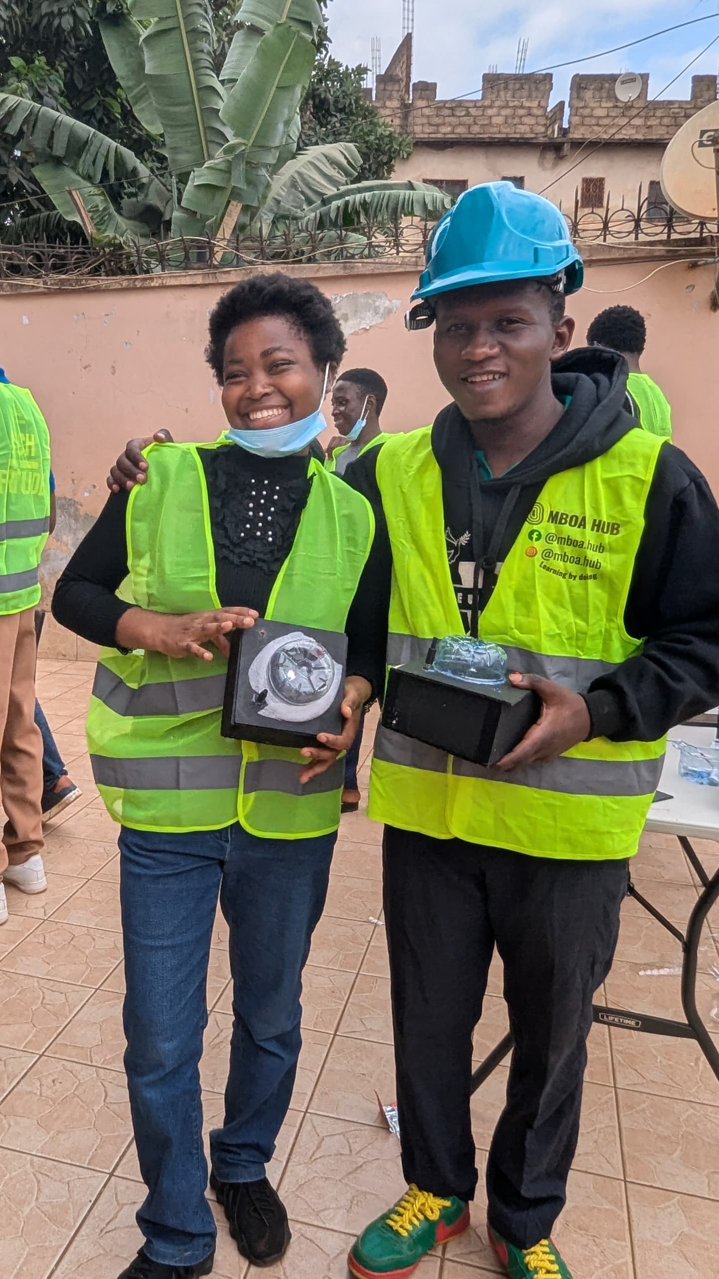 Blaise and one of the trained youths holding two WiseBoxes
